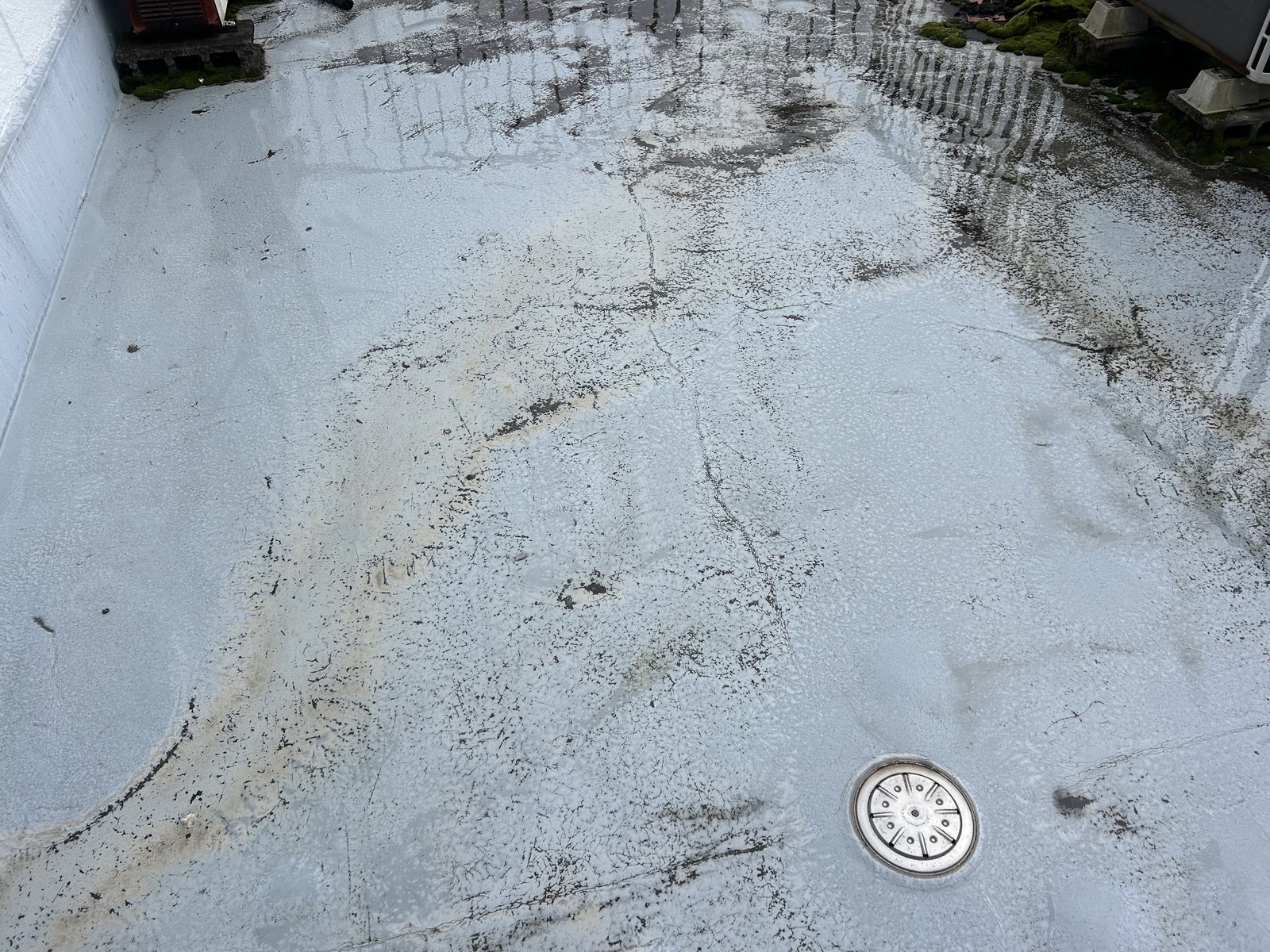 施工前の屋上 既存のウレタン防水にひび割れと汚れが出ている